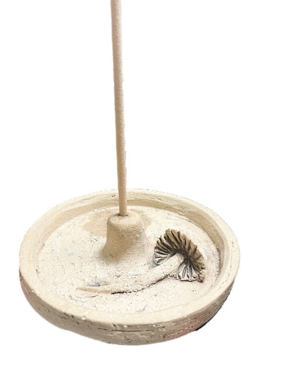 Incense burner with a stick of incense on a white background