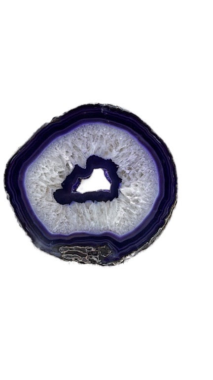 Geode slice with purple interior on a white background