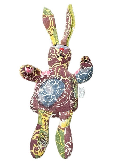 Colorful fabric bunny toy with a patterned design on a white background