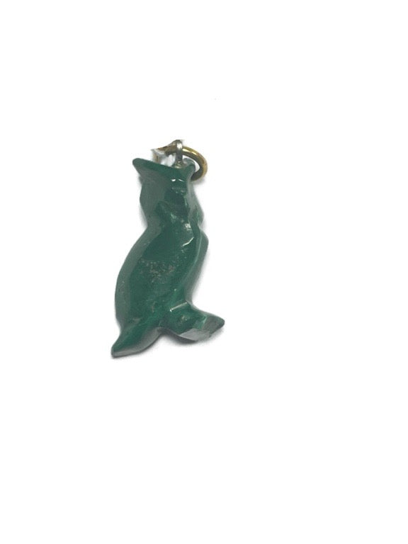Green dolphin-shaped keychain on a white background