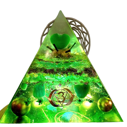Triangular green lamp with decorative elements on a plain background